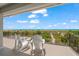 Private deck overlooking the ocean with white adirondack chairs at 600/602 Beach Rd # 1 & 2, Sarasota, FL 34242