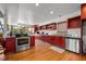 Modern kitchen with stainless steel appliances and red cabinets at 600/602 Beach Rd # 1 & 2, Sarasota, FL 34242