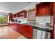 Modern kitchen with stainless steel appliances and red cabinets at 600/602 Beach Rd # 1 & 2, Sarasota, FL 34242