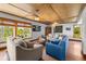 Bright living room featuring hardwood floors, ample seating, and large windows with window coverings at 600/602 Beach Rd # 1 & 2, Sarasota, FL 34242