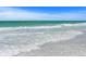 Waves gently lapping on pristine white sand beach at 600/602 Beach Rd # 1 & 2, Sarasota, FL 34242