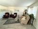 Relaxing living room featuring comfortable seating and hardwood floors at 625 30Th W Ave # G309, Bradenton, FL 34205