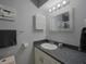 Bathroom with dark countertop, white sink, and a large mirror at 6262 142Nd N Ave # 805, Clearwater, FL 33760