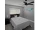 Bright bedroom with a queen bed and ceiling fan at 6262 142Nd N Ave # 805, Clearwater, FL 33760