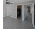 Spacious bedroom with ceiling fan, wood-look floors, and access to closet at 6262 142Nd N Ave # 805, Clearwater, FL 33760