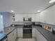 Modern kitchen with stainless steel appliances and dark countertops at 6262 142Nd N Ave # 805, Clearwater, FL 33760
