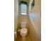 Small bathroom with toilet and window at 636 Lakescene Drive Dr, Venice, FL 34293