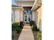 Front entry with double doors, light fixture, and landscaping at 636 Lakescene Drive Dr, Venice, FL 34293