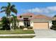 One-story home with tile roof, double doors, and attached garage at 636 Lakescene Drive Dr, Venice, FL 34293