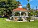 White gazebo with red tile roof in a park at 636 Lakescene Drive Dr, Venice, FL 34293