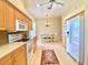 Kitchen with light wood cabinets, white appliances, and breakfast nook at 636 Lakescene Drive Dr, Venice, FL 34293