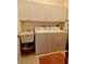 Bright laundry room, washer, dryer, cabinets, and utility sink at 636 Lakescene Drive Dr, Venice, FL 34293
