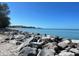 Rocky shoreline with ocean view and distant buildings at 636 Lakescene Drive Dr, Venice, FL 34293