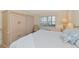 Bright bedroom with a king-size bed and built-in storage at 6999 W Country Club N Dr # 124, Sarasota, FL 34243