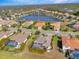 Aerial view of a luxury home community with a lake at 7817 Passionflower Dr, Sarasota, FL 34241
