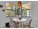 Bright breakfast nook with a round table and four chairs, offering a view of the backyard at 7817 Passionflower Dr, Sarasota, FL 34241