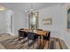 Elegant dining room featuring a wood table, stylish rug, and modern light fixture at 7817 Passionflower Dr, Sarasota, FL 34241
