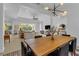 Spacious dining room with a long wooden table and modern lighting at 7817 Passionflower Dr, Sarasota, FL 34241