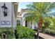 Front entry of home with lush landscaping and brick walkway at 7817 Passionflower Dr, Sarasota, FL 34241