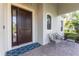 Welcoming front porch with stylish seating and a dark wood door at 7817 Passionflower Dr, Sarasota, FL 34241