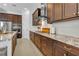 Modern kitchen with dark wood cabinetry, granite countertops, and stainless steel appliances at 7817 Passionflower Dr, Sarasota, FL 34241