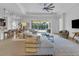 Open concept living room with sectional sofa, and access to the backyard and pool at 7817 Passionflower Dr, Sarasota, FL 34241
