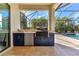 Outdoor kitchen with grill, sink, and refrigerator at 7817 Passionflower Dr, Sarasota, FL 34241