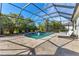 Relaxing pool area with screened enclosure and lounge chairs at 7817 Passionflower Dr, Sarasota, FL 34241