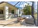 Covered patio with sectional sofa and outdoor kitchen at 7817 Passionflower Dr, Sarasota, FL 34241