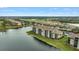 Aerial view of luxury condos with water and golf course views at 7911 Grand Estuary Trl # 106, Bradenton, FL 34212