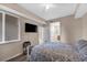 Bright bedroom with a double bed, TV and en-suite bathroom at 7911 Grand Estuary Trl # 106, Bradenton, FL 34212