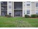 Ground level view of condo building with a screened patio at 7911 Grand Estuary Trl # 106, Bradenton, FL 34212