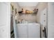 Well-equipped laundry room with washer, dryer, and storage shelves at 7911 Grand Estuary Trl # 106, Bradenton, FL 34212