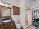 Bathroom with granite countertop, large mirror, and shower at 8107 High Oaks Trl, Myakka City, FL 34251