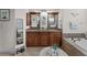 Bathroom boasts double vanity, granite counters, and large mirrors at 8107 High Oaks Trl, Myakka City, FL 34251
