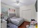 Cozy bedroom with a gray upholstered bed and ample closet space at 8107 High Oaks Trl, Myakka City, FL 34251
