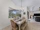 Light-filled dining area, featuring a farmhouse table and pool view at 8107 High Oaks Trl, Myakka City, FL 34251
