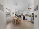 Bright dining area with a farmhouse table and view into the kitchen at 8107 High Oaks Trl, Myakka City, FL 34251