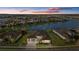 Luxury waterfront property in a residential community at dusk at 9020 Artisan Way, Sarasota, FL 34240