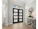 Bright and airy entryway with double doors, wood floors and console table at 9020 Artisan Way, Sarasota, FL 34240