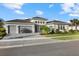 Stunning single-story home with a three-car garage, stone accents and beautiful landscaping at 9020 Artisan Way, Sarasota, FL 34240