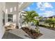 Relaxing front porch with paver patio, palm trees and seating area at 9020 Artisan Way, Sarasota, FL 34240