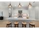 Bright kitchen boasts an expansive island with seating and sleek countertops at 9020 Artisan Way, Sarasota, FL 34240