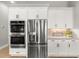 Modern kitchen with stainless steel appliances and white cabinets at 9020 Artisan Way, Sarasota, FL 34240