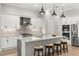 Open kitchen with island, stainless steel appliances, and white cabinetry at 9020 Artisan Way, Sarasota, FL 34240