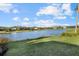 Serene lake view with lush landscaping and homes in the background at 9020 Artisan Way, Sarasota, FL 34240