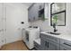 Functional laundry room with washer, dryer, and extra storage at 9020 Artisan Way, Sarasota, FL 34240