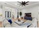Spacious living room with sectional sofa and large TV at 9020 Artisan Way, Sarasota, FL 34240