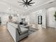 Open concept living area with sectional sofa and kitchen access at 9020 Artisan Way, Sarasota, FL 34240