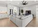Open concept living room with sectional sofa and kitchen at 9020 Artisan Way, Sarasota, FL 34240